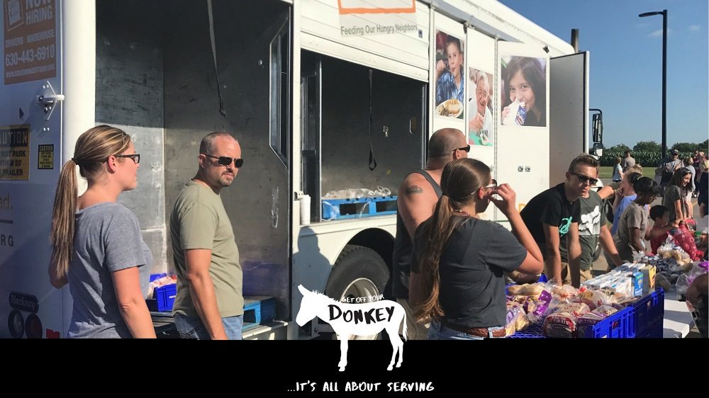 The people are getting off their donkey to help others at The Village Christian Church in MInooka, IL